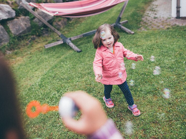Kinder spielen mit den Seifenblasen auf der Wiese | © Urlaub am Bauernhof Kärnten / Daniel Gollner