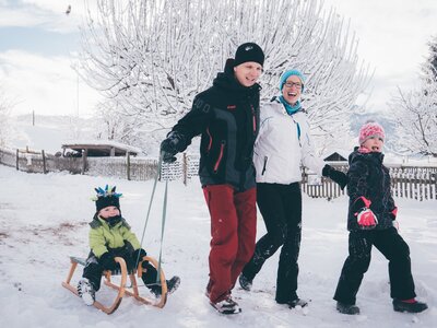 Familie mit dem Schlitten | © Urlaub am Bauernhof Kärnten / Daniel Gollner Familie geht mit dem Schlitten am Weg | © Urlaub am Bauernhof Kärnten / Daniel Gollner
