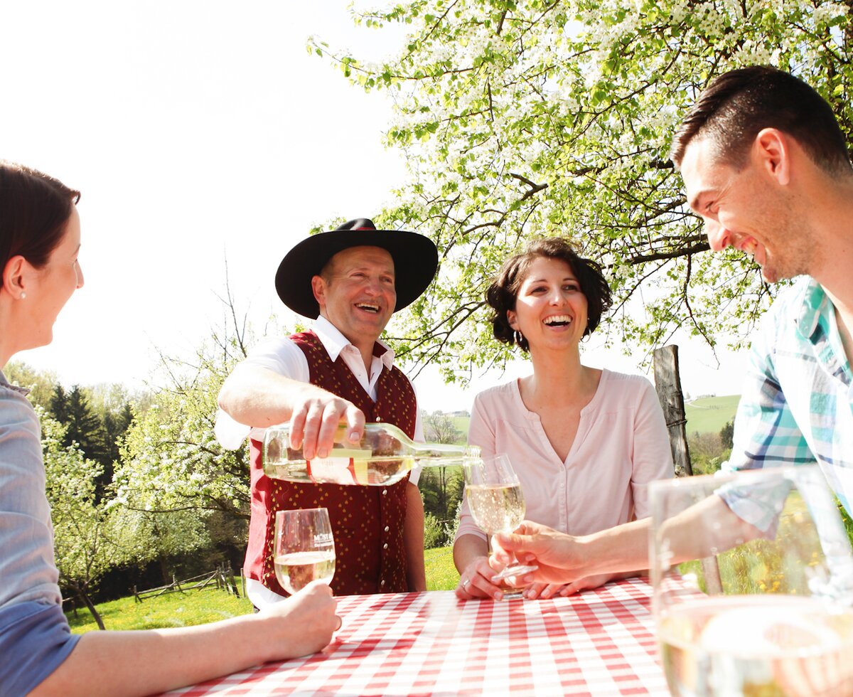 Drinking cider outdoors | © Mostviertel Tourismus / schwarz-koenig.at People drinking cider outdoors by the table | © Mostviertel Tourismus / schwarz-koenig.at
