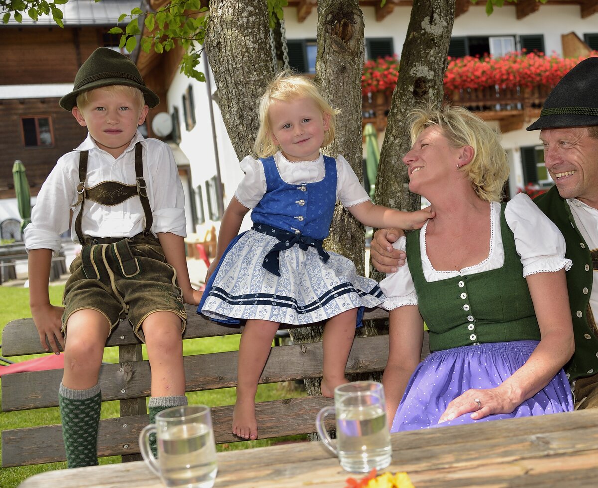 Familie in Tracht sitzt auf der Terrasse | © Urlaub am Bauernhof Oberösterreich / Ralph Fischbacher