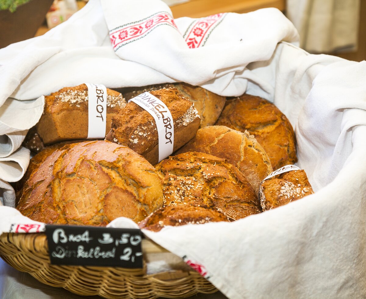 Selbstgebackene Brotlaibe im Brotkorb, halb zugedeckt mit einem weißen Tuch, Zieferhof Hofladen, Salzburger Land | © Urlaub am Bauernhof / Bernd Suppan