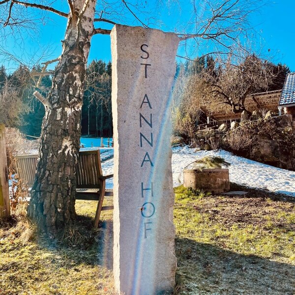 The entrance sign for the Farm House, a stone pillar carved with "ST ANNA HOF".